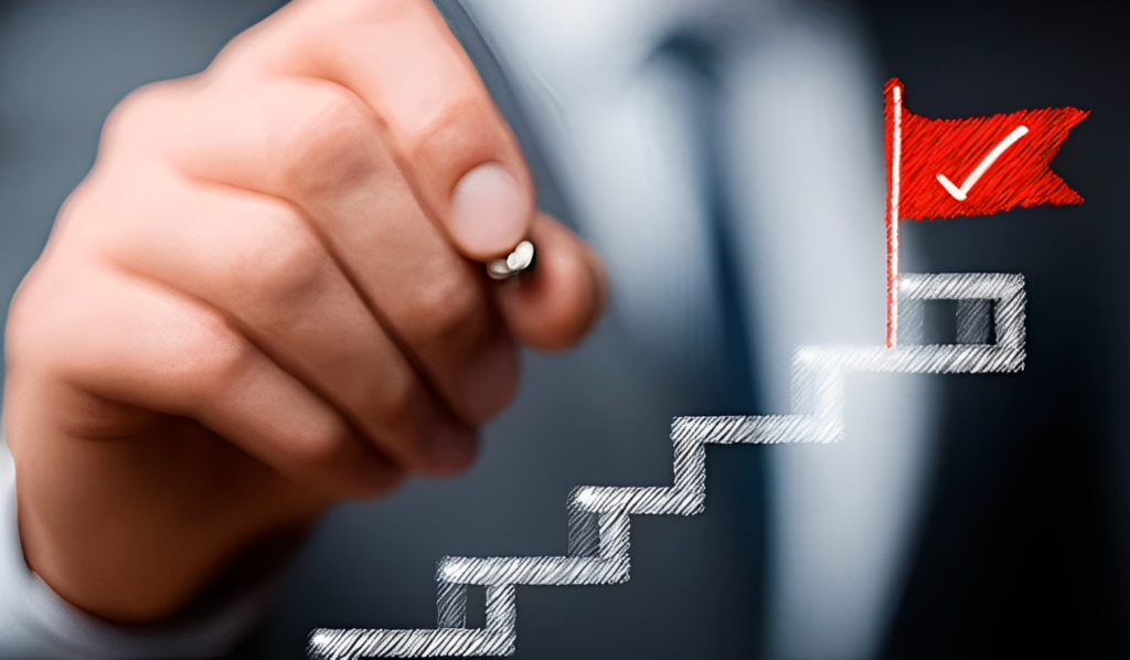 階段状のグラフを指で描くビジネスマンの手元